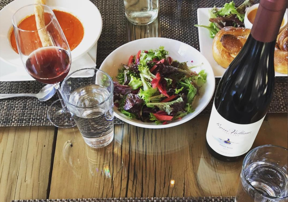 Plated Food and Wine on Table in The Tasting Barn